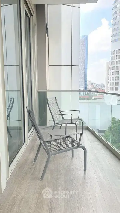 Modern balcony with city view and stylish seating, ideal for relaxation.