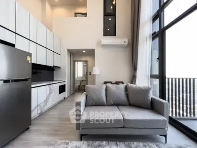 Modern living room with sleek kitchen and large windows offering stunning views.