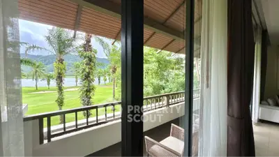 Luxurious balcony view overlooking lush greenery and serene lake, perfect for relaxation.