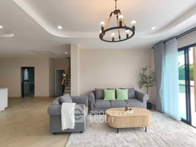 Spacious modern living room with elegant chandelier and cozy seating area