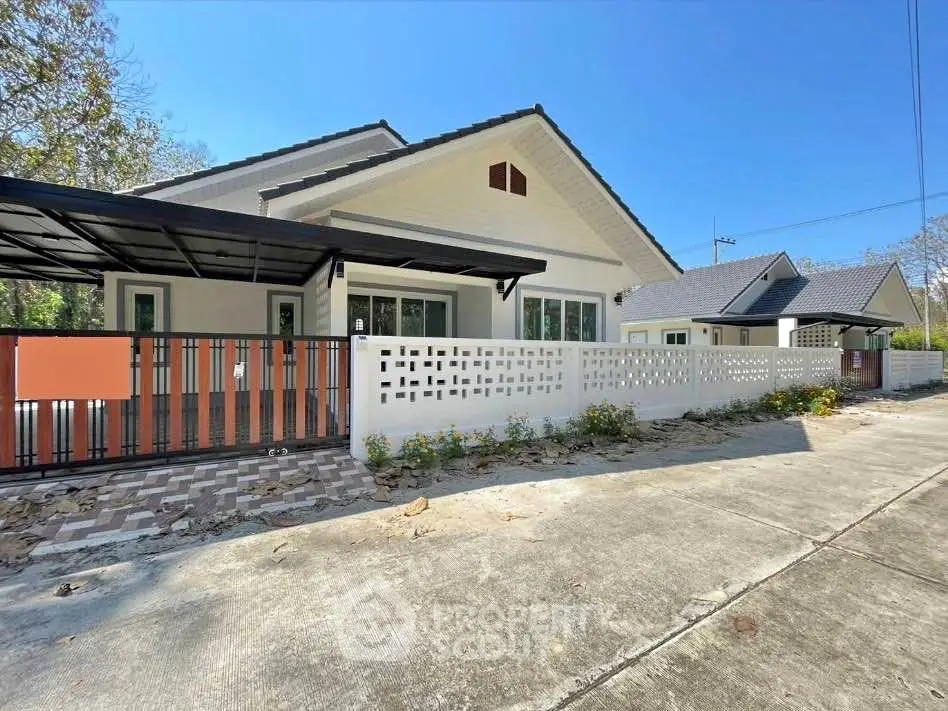 Charming single-story home with modern design and spacious driveway in serene neighborhood.