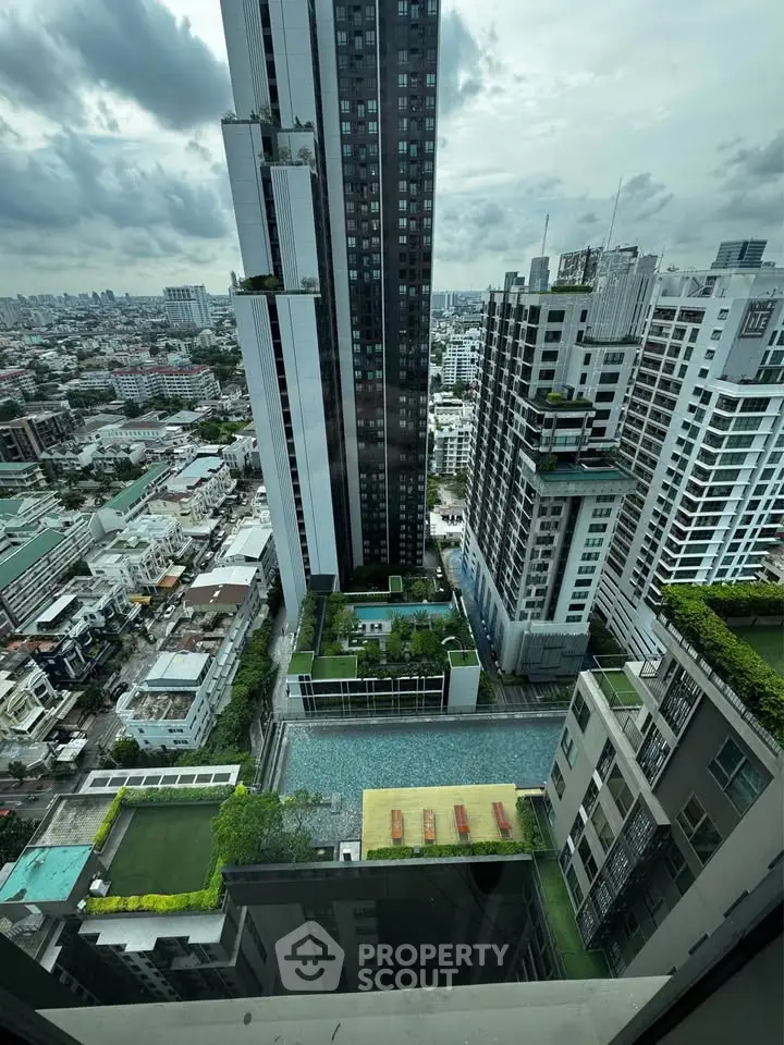 Stunning high-rise cityscape view with luxurious pool and modern architecture.