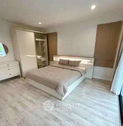 Modern bedroom with stylish decor and ample natural light