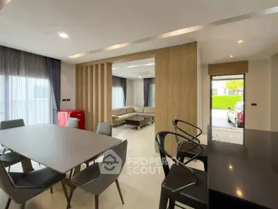 Spacious modern living and dining area with stylish furniture and natural light.