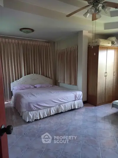 Spacious bedroom with elegant decor and ample natural light