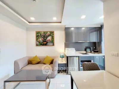 Modern living room with sleek kitchen, cozy sofa, and stylish decor in open layout apartment.