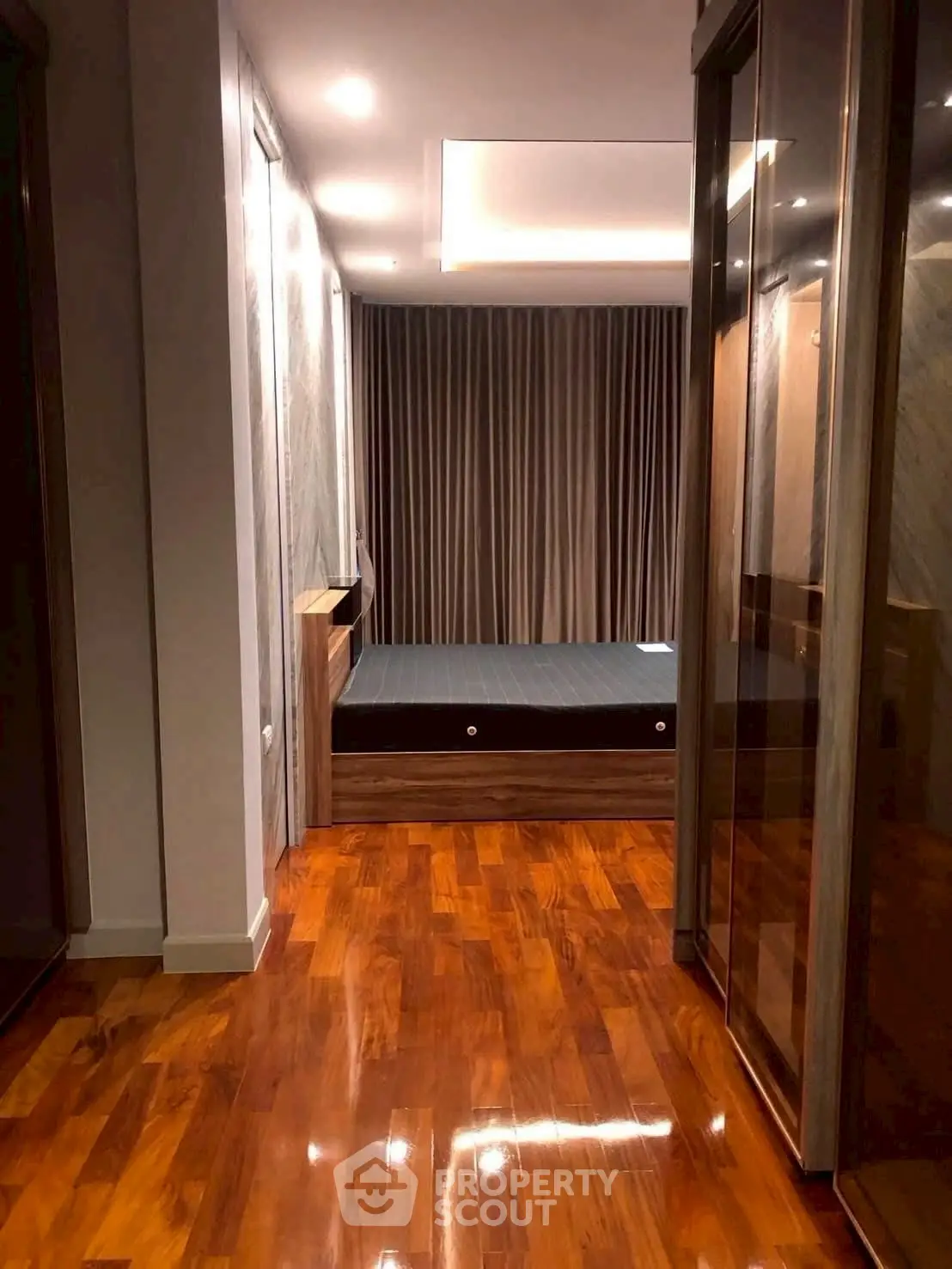Luxurious bedroom with polished wooden floors and elegant lighting