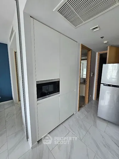 Modern kitchen with sleek cabinetry and built-in appliances in a stylish apartment.