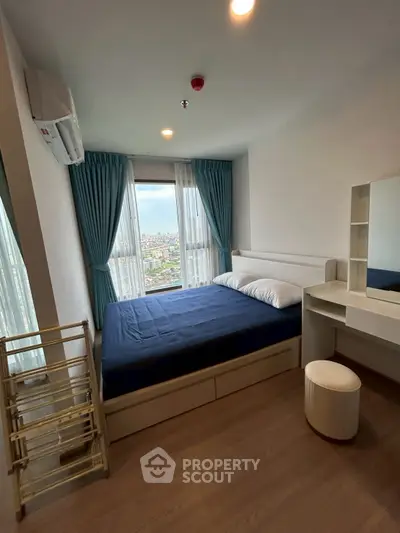 Modern bedroom with city view, featuring a cozy bed and stylish decor.