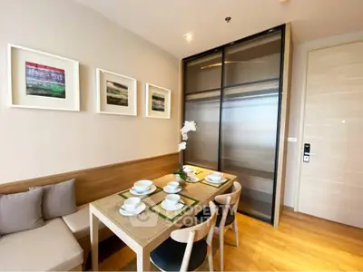 Modern dining area with elegant table setting and stylish decor in a cozy apartment.