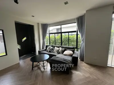 Spacious modern living room with large windows and stylish furniture