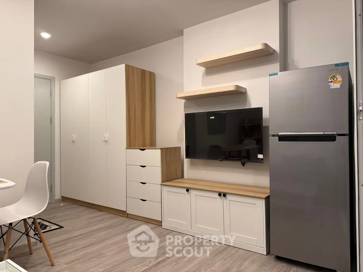 Modern living room with sleek furniture and mounted TV in stylish apartment