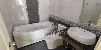 Modern bathroom with sleek bathtub and stylish sink design.