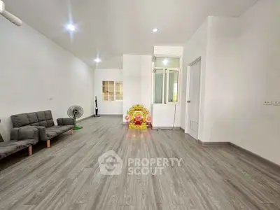 Spacious minimalist living room with modern flooring and simple decor