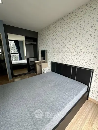 Modern bedroom with stylish wallpaper and large mirror wardrobe