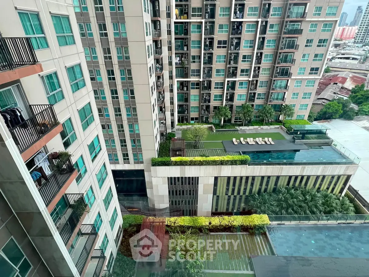 Stunning high-rise building with lush rooftop garden and pool view in urban setting.