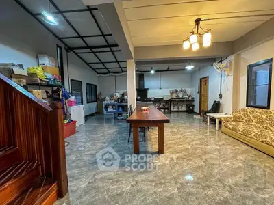 Spacious open-plan living area with modern lighting and tiled flooring