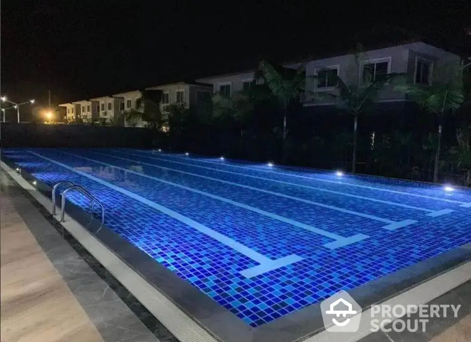 Luxurious night view of illuminated swimming pool in upscale residential area