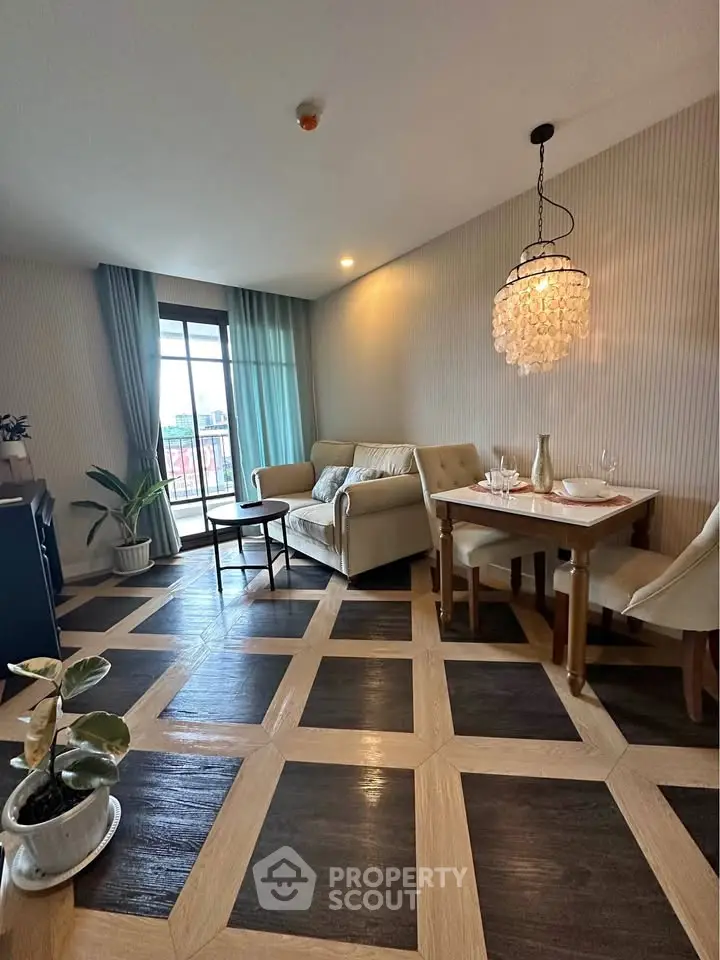 Stylish living room with elegant decor and balcony view, featuring modern furniture and chic lighting.