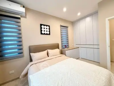 Modern bedroom with cozy bed, stylish decor, and ample storage space