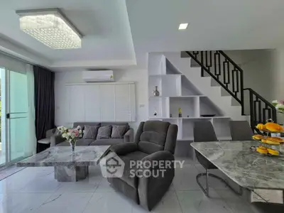 Modern living room with elegant marble tables and stylish staircase
