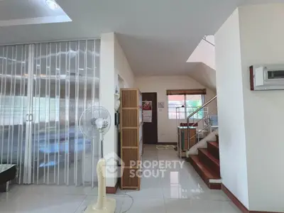 Spacious modern living area with staircase and sliding partition