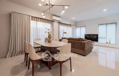 Elegant modern living room with dining area, featuring stylish furniture and ambient lighting.