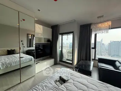 Luxurious bedroom with city view, elegant decor, and spacious balcony access.