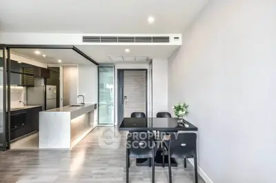 Modern open-layout kitchen and dining area with sleek design and natural light.