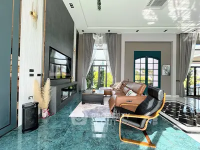 Luxurious living room with modern decor, large windows, and elegant furnishings, offering a spacious and inviting atmosphere.