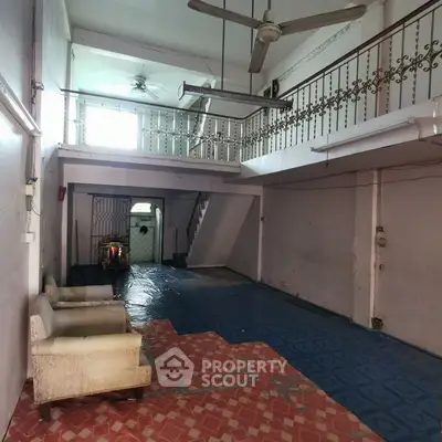 Spacious interior with high ceilings and mezzanine, ideal for creative renovation.