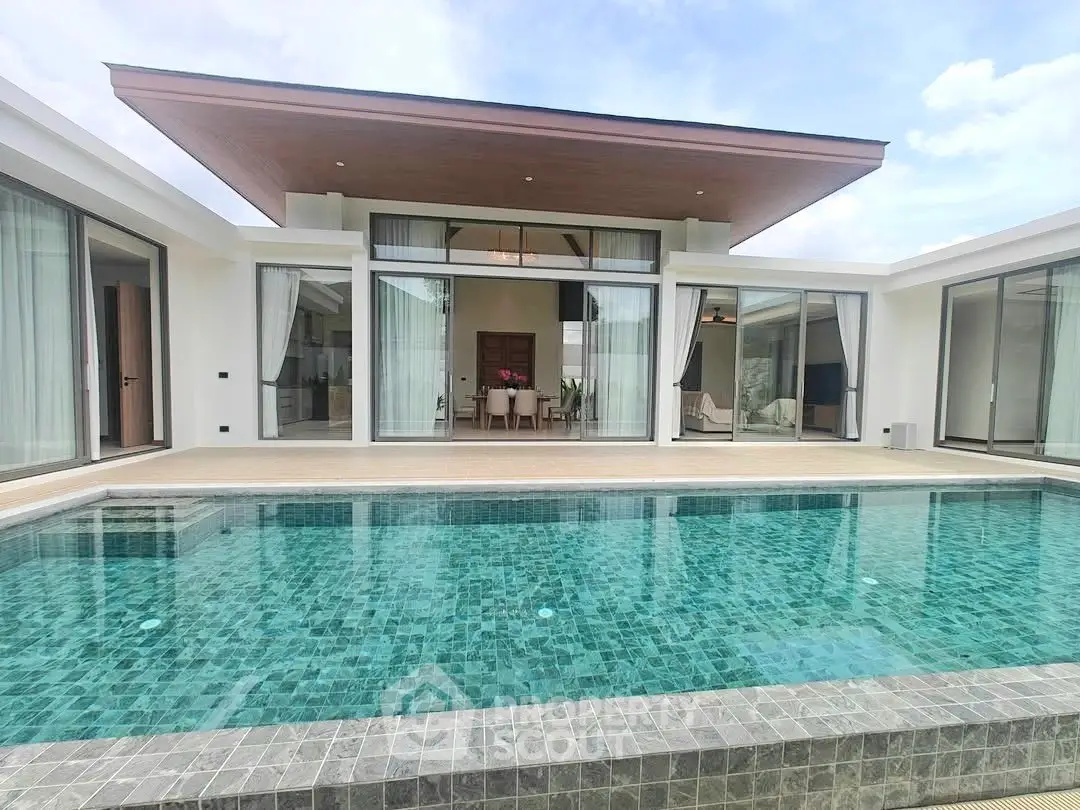 Luxurious modern villa with private pool and expansive glass doors, perfect for serene living.