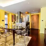 Stylish dining area with modern decor and vibrant yellow walls