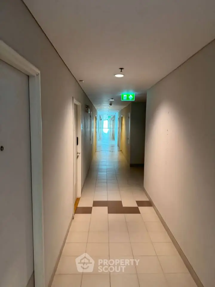 Modern apartment hallway with tiled flooring and bright lighting