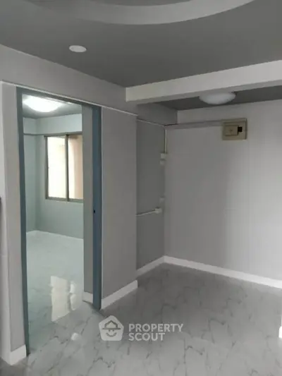 Modern minimalist interior with sleek gray walls and marble flooring, perfect for contemporary living.