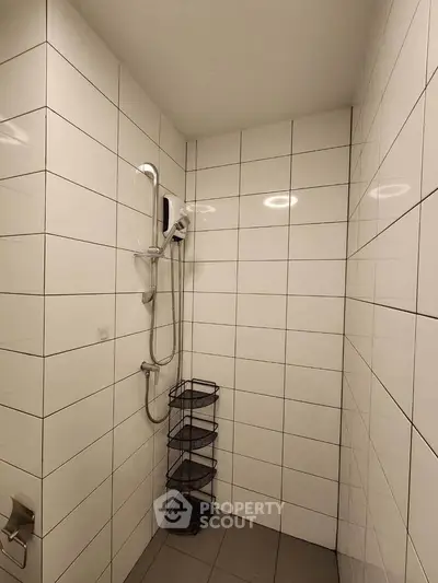 Modern tiled bathroom with shower and storage rack