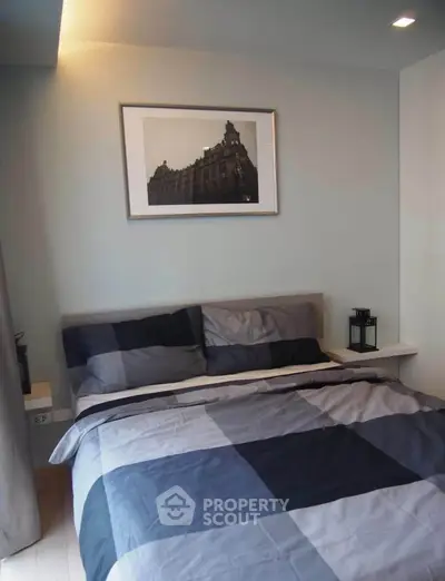 Cozy bedroom with modern decor and framed artwork, perfect for relaxation.