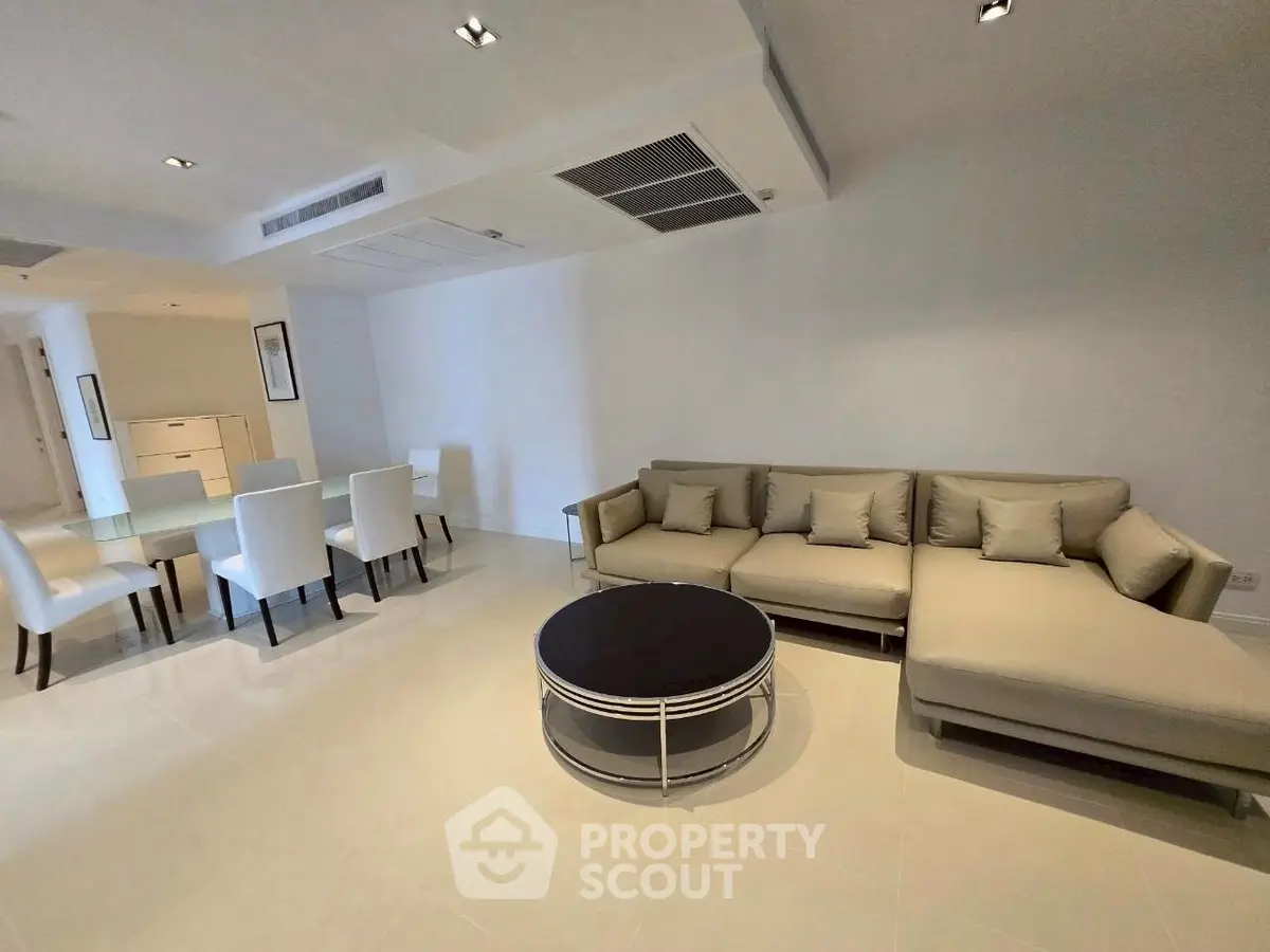 Spacious modern living room with elegant dining area and stylish furniture.