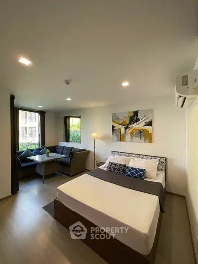 Modern studio apartment with stylish decor and cozy seating area