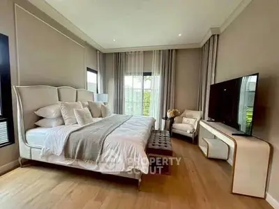 Luxurious bedroom with elegant decor and large windows for natural light.