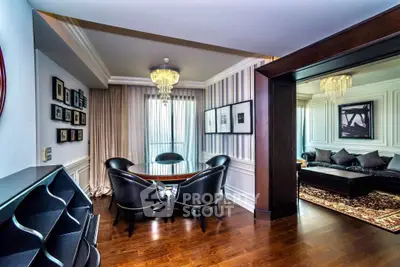 Luxurious living room with elegant dining area and chandelier lighting