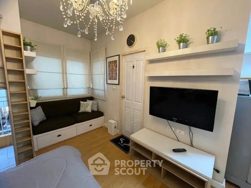 Charming living room with elegant chandelier and modern decor in cozy apartment.