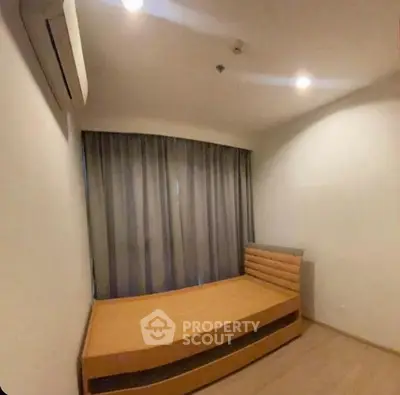 Cozy minimalist bedroom with single bed and air conditioning, ideal for compact living spaces.