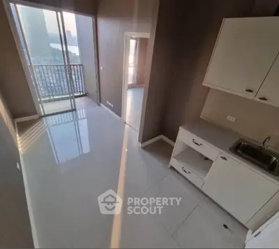 Modern apartment with sleek kitchen and balcony view