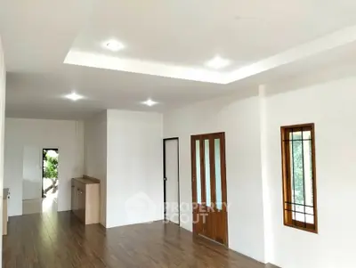 Spacious modern living room with wooden flooring and elegant ceiling lights