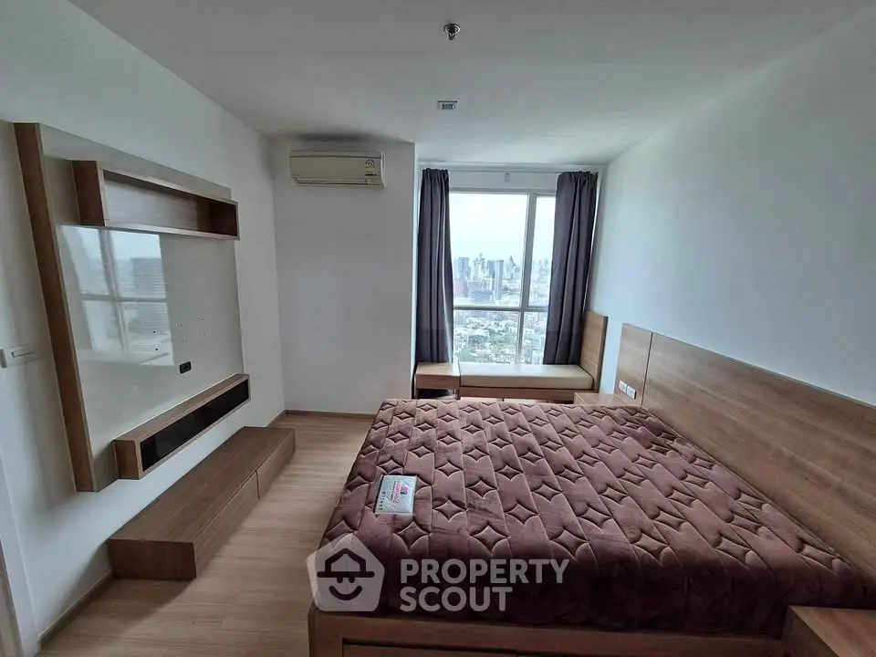 Modern bedroom with city view, featuring a cozy bed and sleek wooden furnishings.