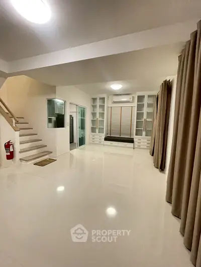 Spacious modern living room with sleek design and ample natural light