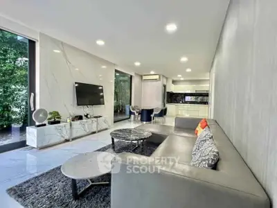 Luxurious modern living room with sleek design and open kitchen layout, perfect for stylish urban living.
