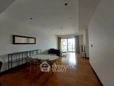 Spacious living room with modern furniture and large window view