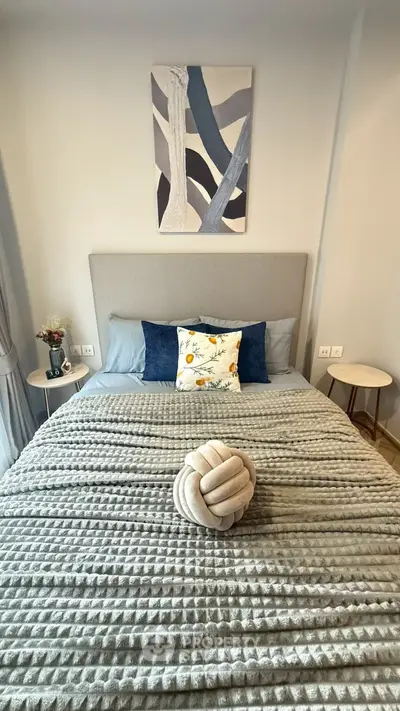 Cozy bedroom with stylish decor and plush bedding